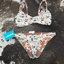Load image into Gallery viewer, hooey lady’s swim suit set cream cow print reversible hooey logo